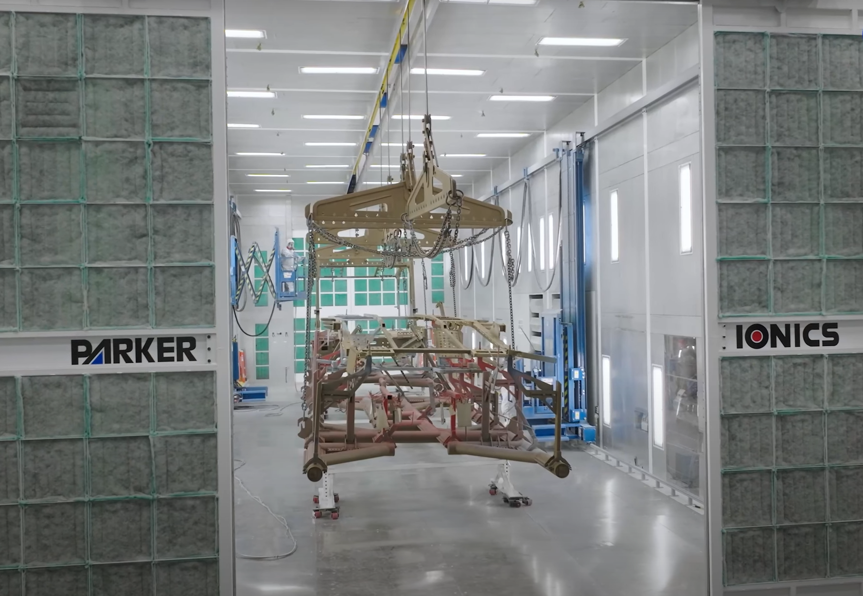 a man powder coats in a powder coating booth from Parker Ionics